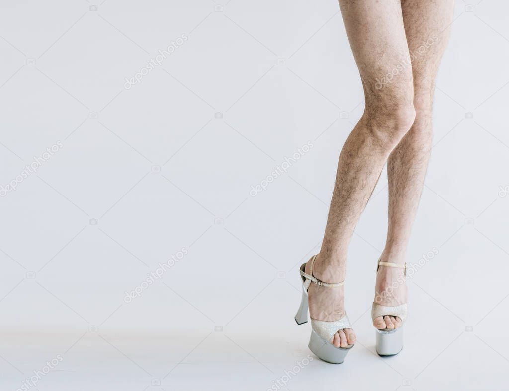 Hairy legs in high heels in pink panties isolated on white background