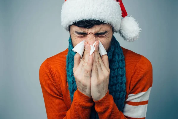 Young bearded man isolated over background. Sick ill person sneezing into white napkin. Flu or influenza. Sickness time. Suffer from nose running. — Stock Photo, Image