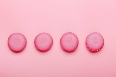 Pembe arka planda pembe kurabiyeler. Tatlılar, pastalar, abur cuburlar. Minimum bileşim. Üst manzara, düz uzanma.