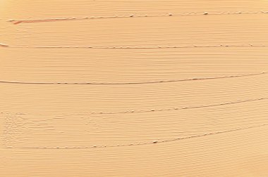 Sıvı tonal temel dokusu. Krem rengi çıplak makyaj lekesi. Profesyonel yüz estetiği ve güzellik konsepti. Soyut şekil. Kopyalama alanı olan bej arkaplan.