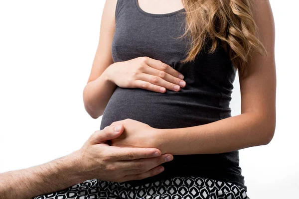 Handen van vrouw en man op buik — Stockfoto