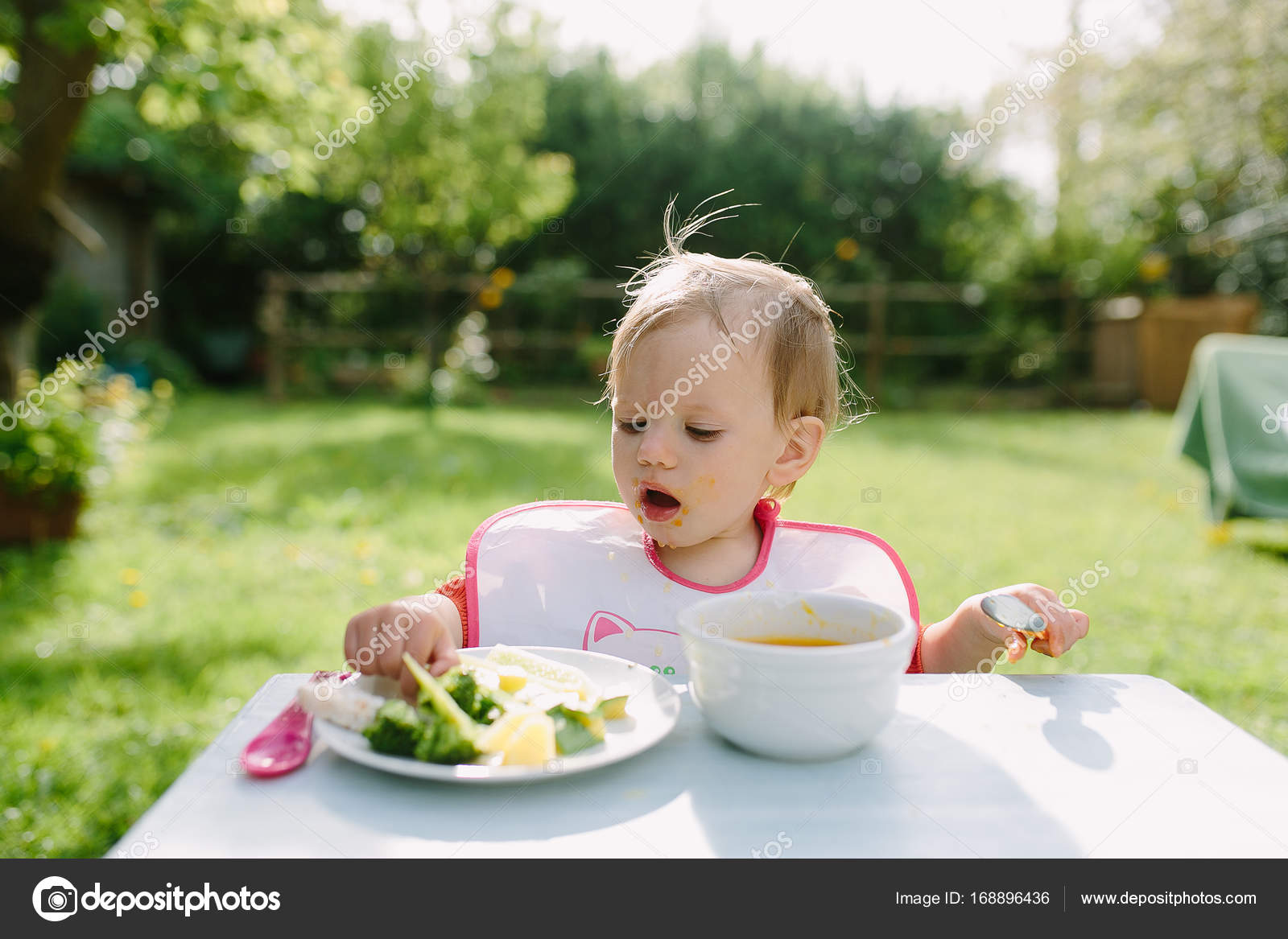 Baby girl eating puree — Stock Photo © Iatanni #168896436