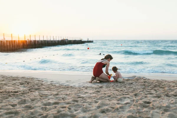 Bebé niña y madre en la playa del mar — Foto de Stock