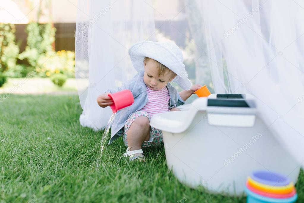  little girl playing with cup 