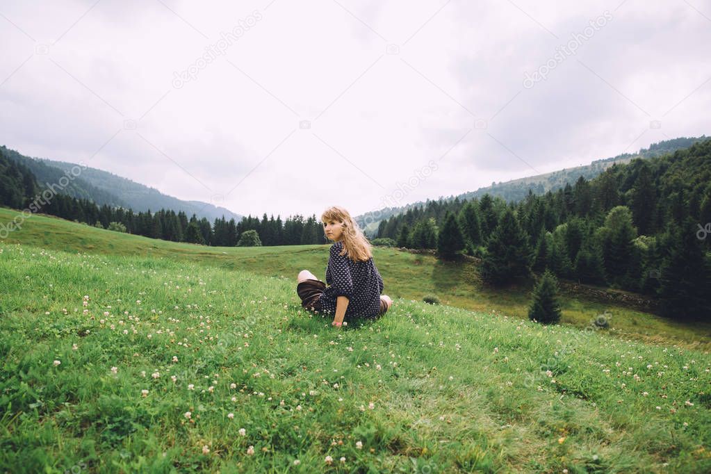 young woman sitting on grass