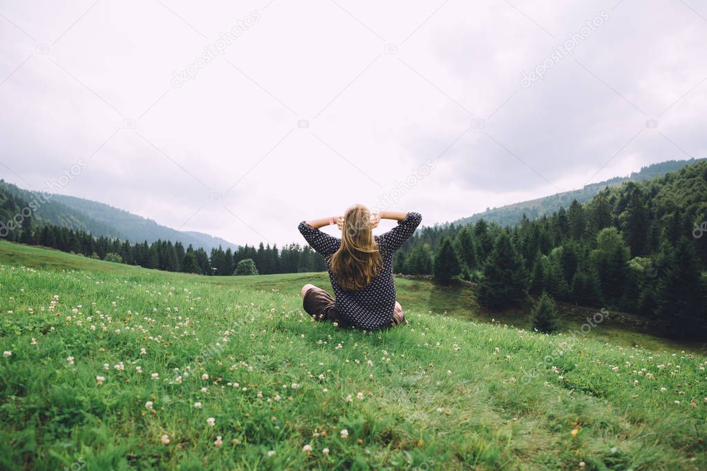 young woman sitting on grass