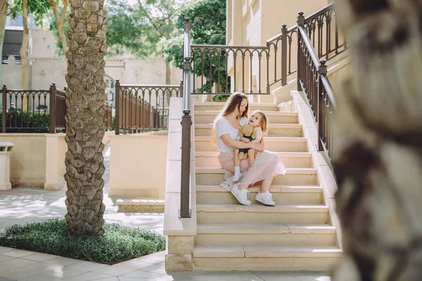 Happy Beautiful Mother Kissing Her Adorable Little Daughter Sitting Stairs — Stock Photo, Image