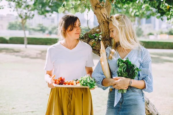 young happy women with healthy food for summer picnic outdoor