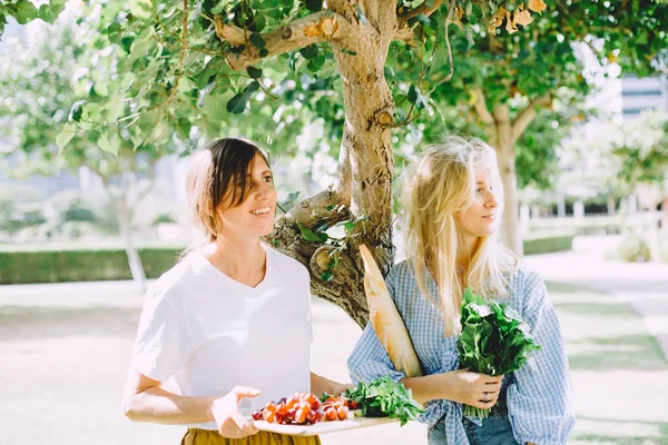 young happy women with healthy food for summer picnic outdoor