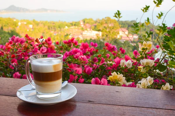 Meeting a brand new day on a tropical island with a splendid view and a cup of cappuccino.