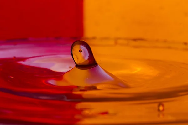 Drops, sprays, splashes of water on a colorful background — Stock Photo, Image