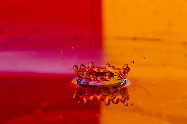 Drops, sprays, splashes of water on a colorful background — Stock Photo, Image