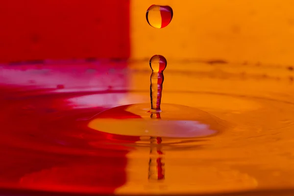 Drops, sprays, splashes of water on a colorful background — Stock Photo, Image