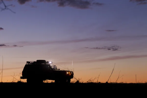 Silueta SUV en el fondo del cielo puesta del sol — Foto de Stock