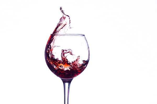 Wine splashing in glass — Stock Photo, Image