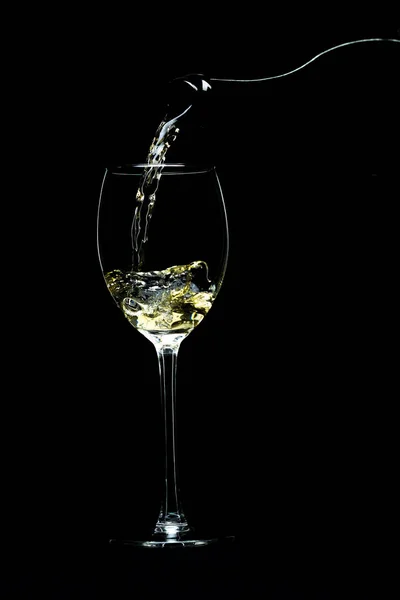Víno nalil do sklenice na černém pozadí — Stock fotografie