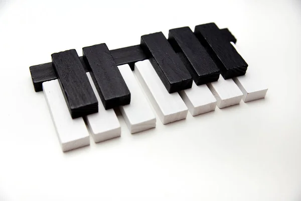 Piano keys on a white background. Learn music. School of Music. Toy piano.