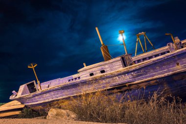 Abandoned boats used by immigrants to reach the coasts of Sicily clipart