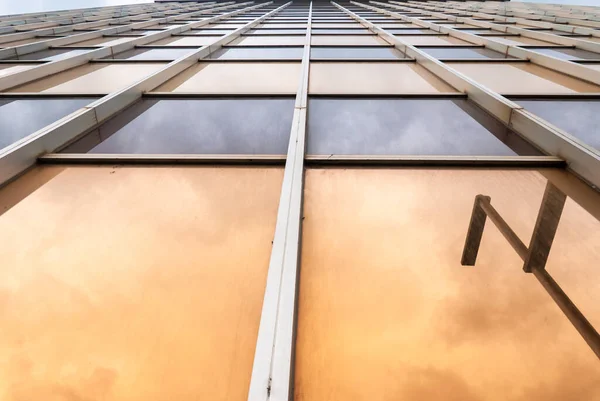 Perspective of a glazed building with orange and blue tones. Abstract composition