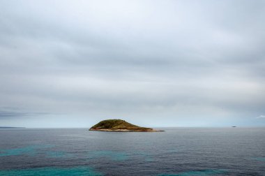 Sa Porrassa Island seen from Magaluf beach on a cloudy day clipart