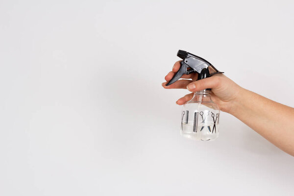 spray bottle with water in the woman's hand