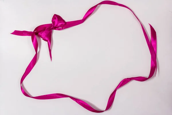 Marco festivo de cinta rosa y lazo — Foto de Stock