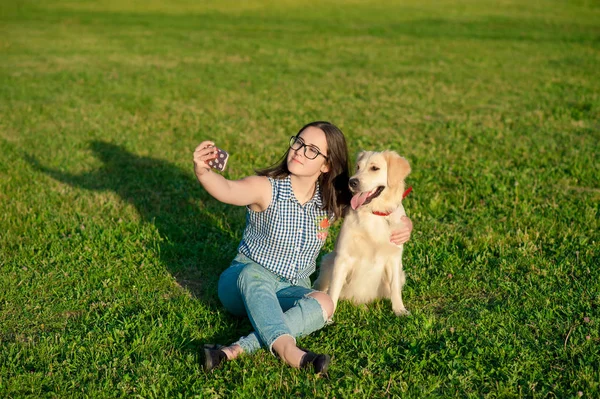 Genç kadının köpeği ile selfie yapması portresi