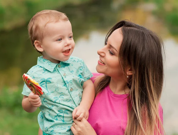 Happy mother holds cute smiling son — Stock Photo, Image