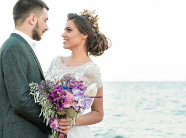 Gelin ve damat düğün töreninde deniz kenarında