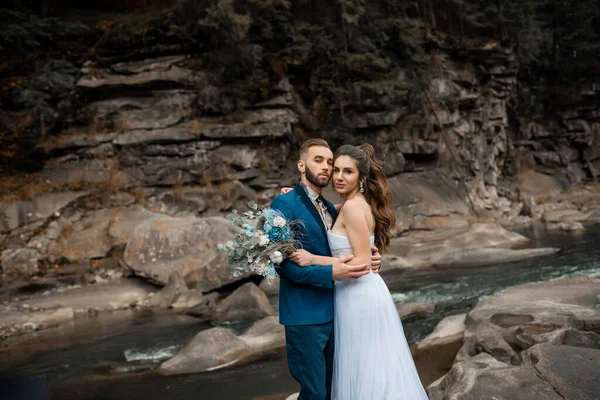 Happy marriage couple in love having eyes full of happiness. Loving man and woman at marriage day. Newlyweds holding hands. bearded groom and bride