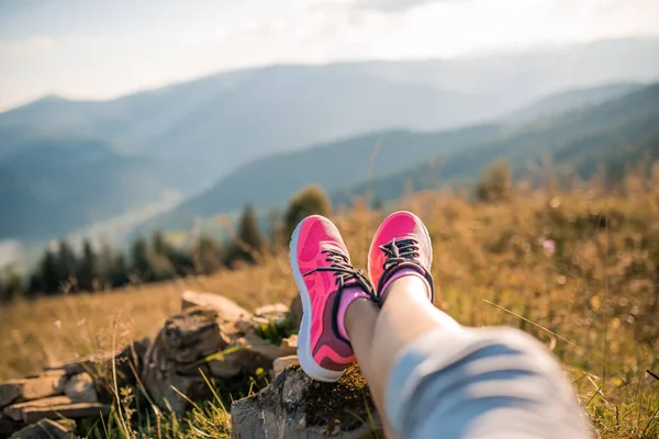 Walking or running legs on mountain road, adventure and exercising in summer nature. Runner girl jogging feet closeup running shoes banner panorama. Lifestyle adventure vacations concept
