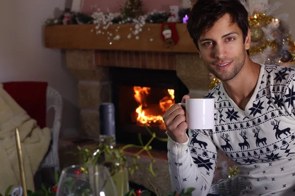 Attractive young man drinking a hot drink — ストック写真