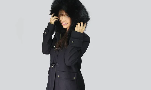 Young woman wearing winter coat with the faux - fur hood — Stock Photo, Image