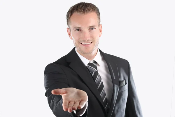 Handsome young man in suit holding his hand out — Stock Photo, Image