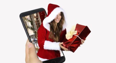 Mutlu neşeli kadın kırmızı Noel Baba kıyafeti bir akıllı telefon dışarı geliyor. Beyaz bir arka plan üzerinde Noel kavramı 