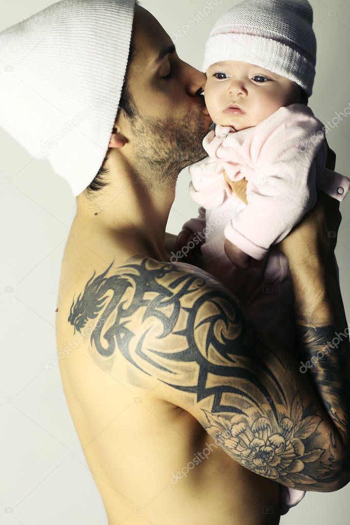 Handsome man holding baby on a white background 