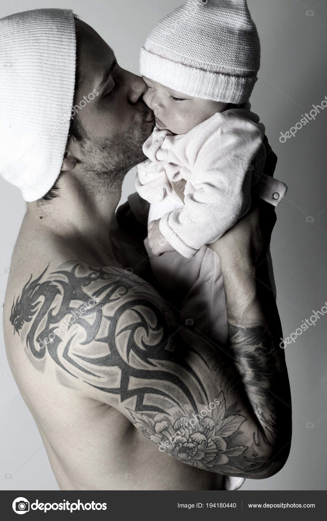 Handsome Tattoo Dad Kissing His Baby Stock Photo by ©rdrgraphe 194180440