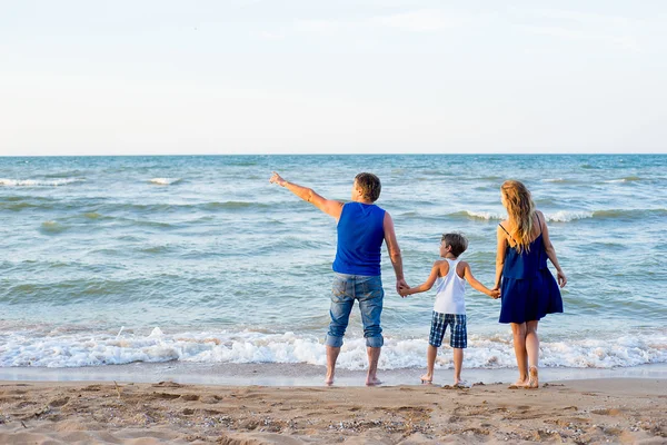Family of three having fun at the beach — Stock Photo, Image