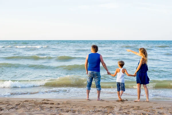 Family of three having fun at the beach — Stock Photo, Image