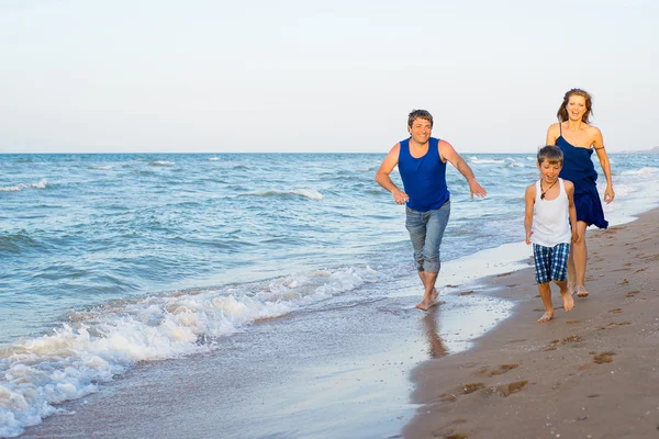 Family of three having fun at the beach — Stock Photo, Image