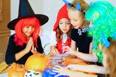 Happy group of children in costumes during Halloween party clipart