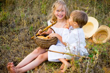 Kız ve erkek kardeşim çimlere oturup