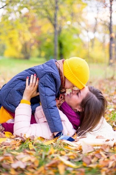Family lying on the leaves autumn park — Stock Photo, Image