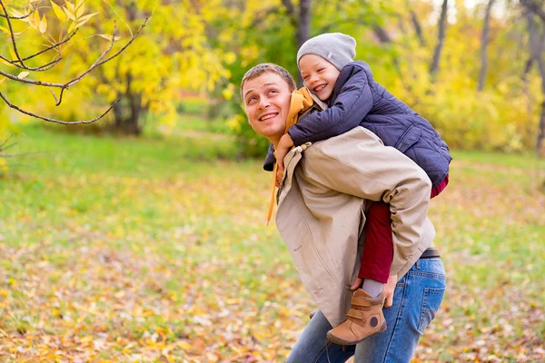 Father With Young Son On his back Autumn Park — Stock Photo, Image