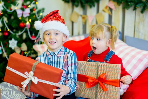 Boy and girl give Christmas gift Stock Photo