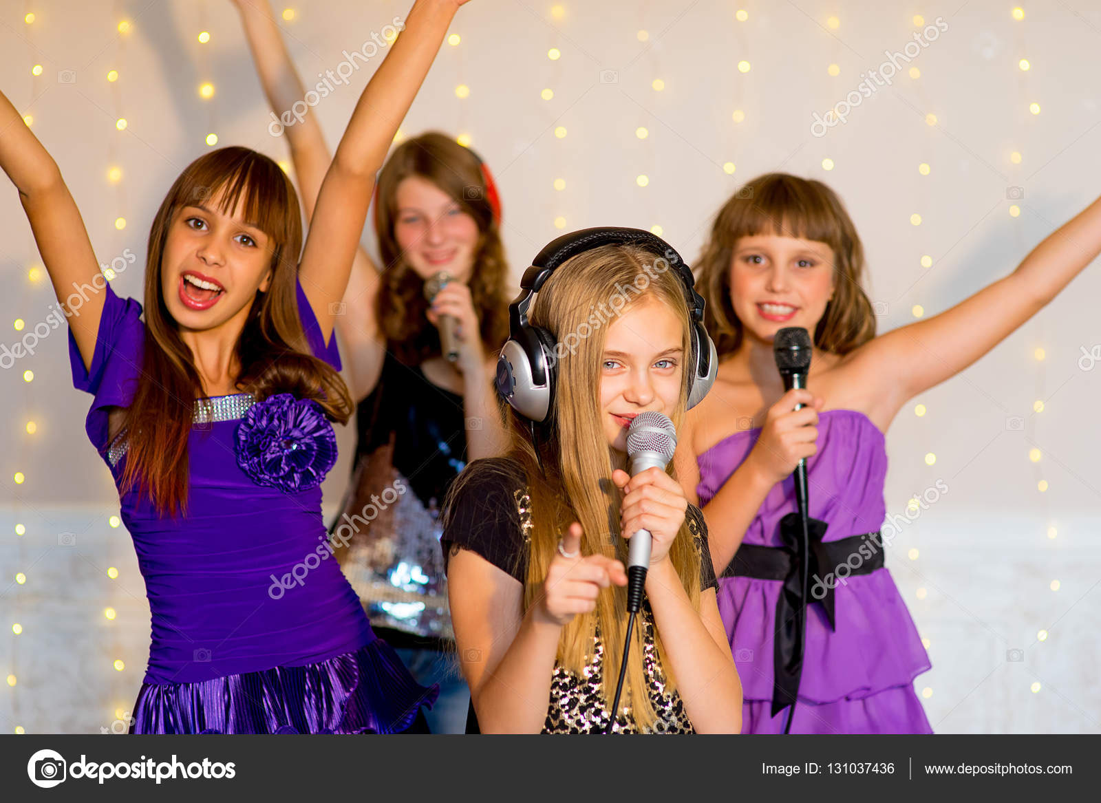 Group of happy girls singing on karaoke — Stock Photo