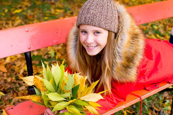 Preteen girl in autumn park with leafs — Stock Photo, Image