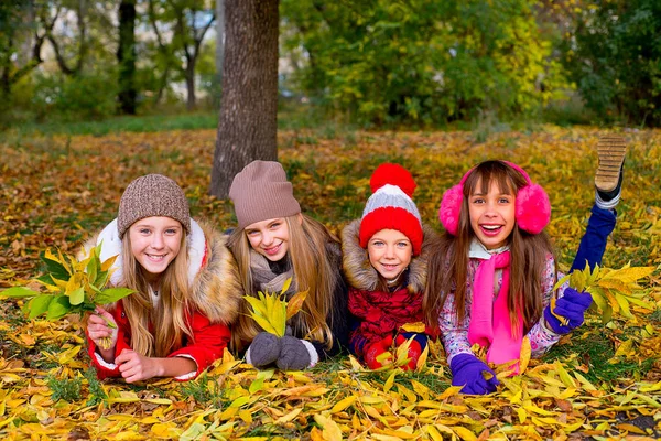 Group of girls in autumn park with leafs — Stock Photo, Image