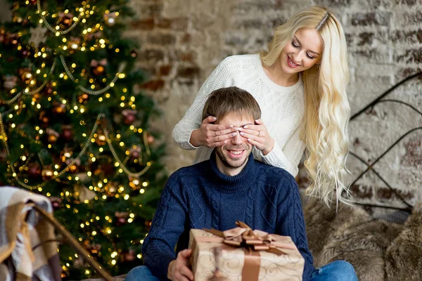 christmas couple, happy young female surprise man cover his eyes