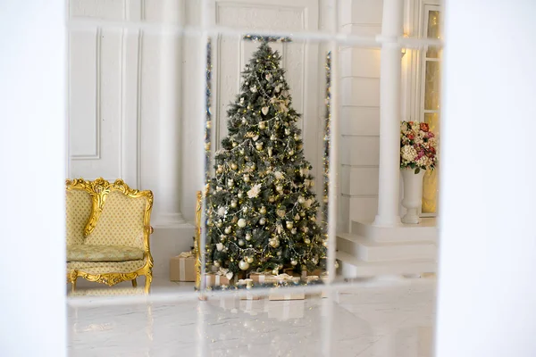 Stylish Christmas interior decorated in white and golden colors